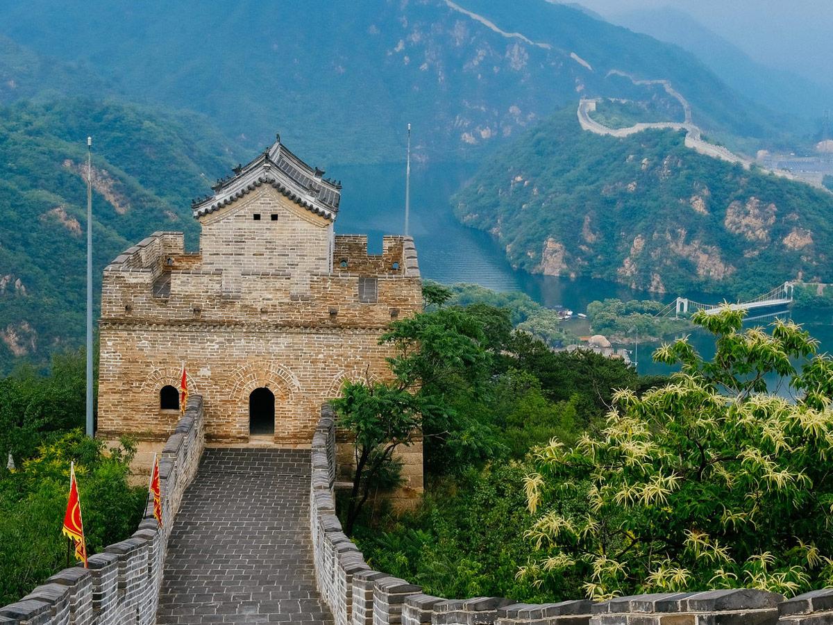 A large tower overlooks the lake at the Huanghuacheng Lakeside Great Wall.